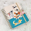 Notebook with dog illustrations on a textured surface | Yarn Worx