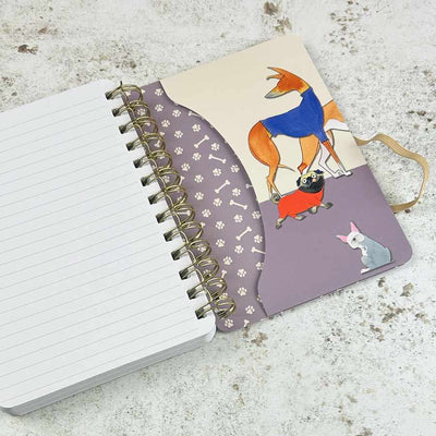 Notebook with spiral binding and a cover featuring cartoon dogs on a textured surface | Yarn Worx