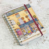 Notebook with a colorful illustration of a street scene on a textured surface | Yarn Worx