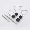 Collection of metal knitting needles and black cable ends on a white background | Yarn Worx