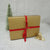Christmas Yarn Gift in a gold gift tied with a red ribbon | Yarn Worx